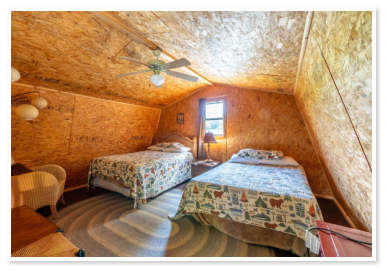 loft with two beds in one of one of our cabins