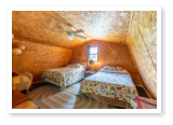 loft with two beds in one of one of our cabins